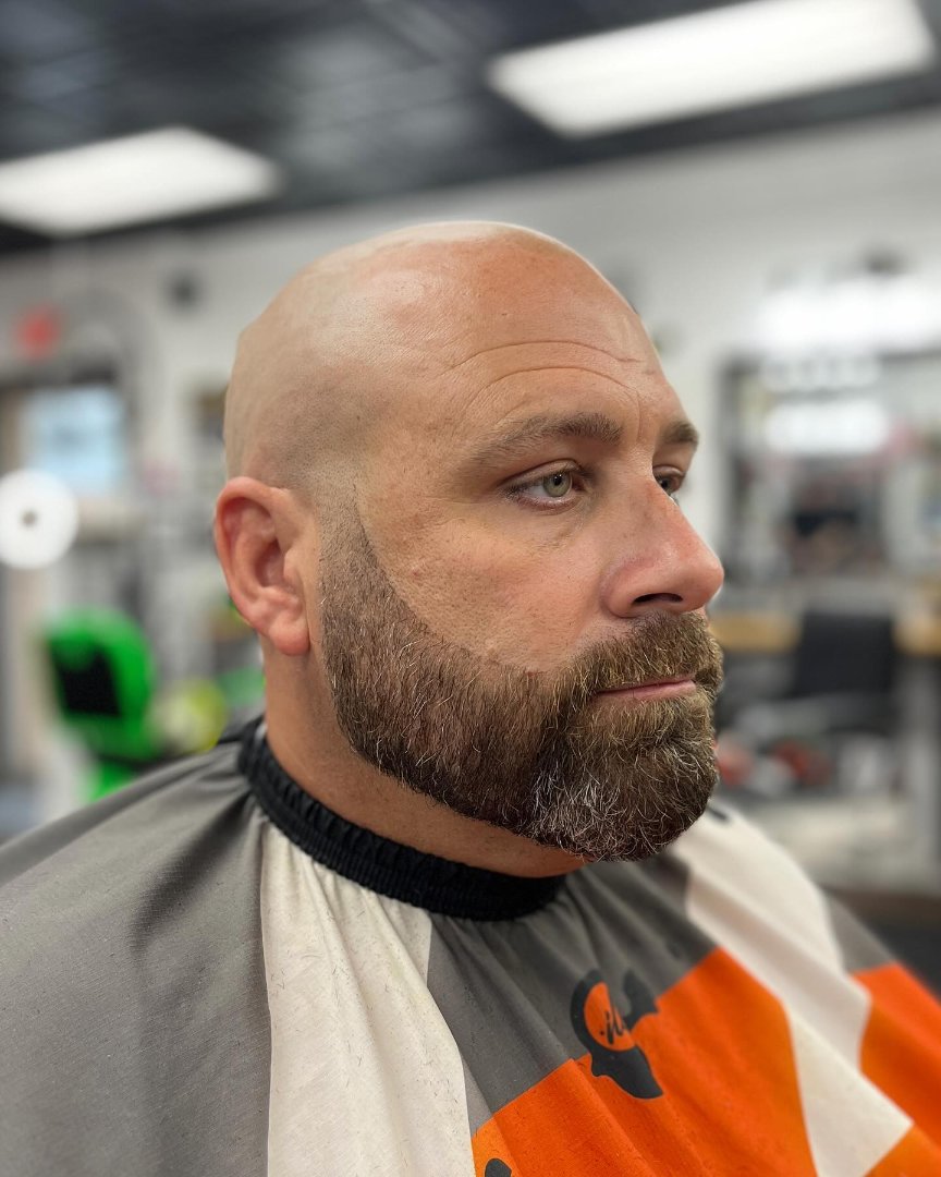 Bald fade with a full sculpted beard